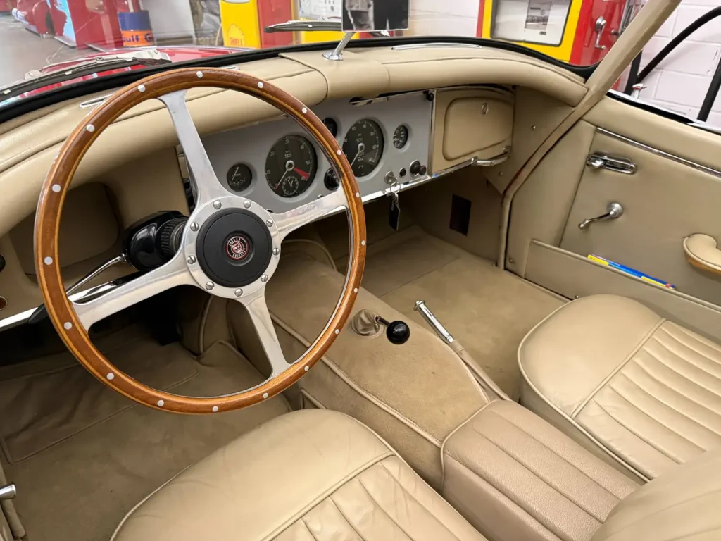Jaguar XK150 1958 rot Sicht auf Lenkrad und Frontsitze.
